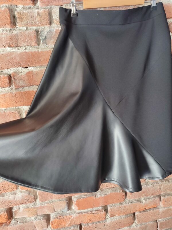 Black asymmetrical skirt in eco leather
